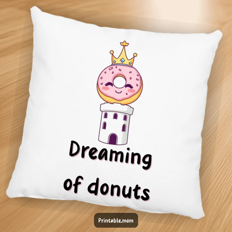 Funny pillow featuring a smiling donut wearing a tiny crown, balancing precariously on a decorative tower.