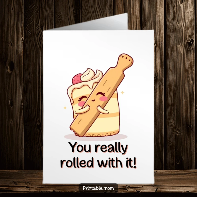 Funny Free Printable Congrats Card: A happy cake in a comical embrace with a giant rolling pin, celebrating.